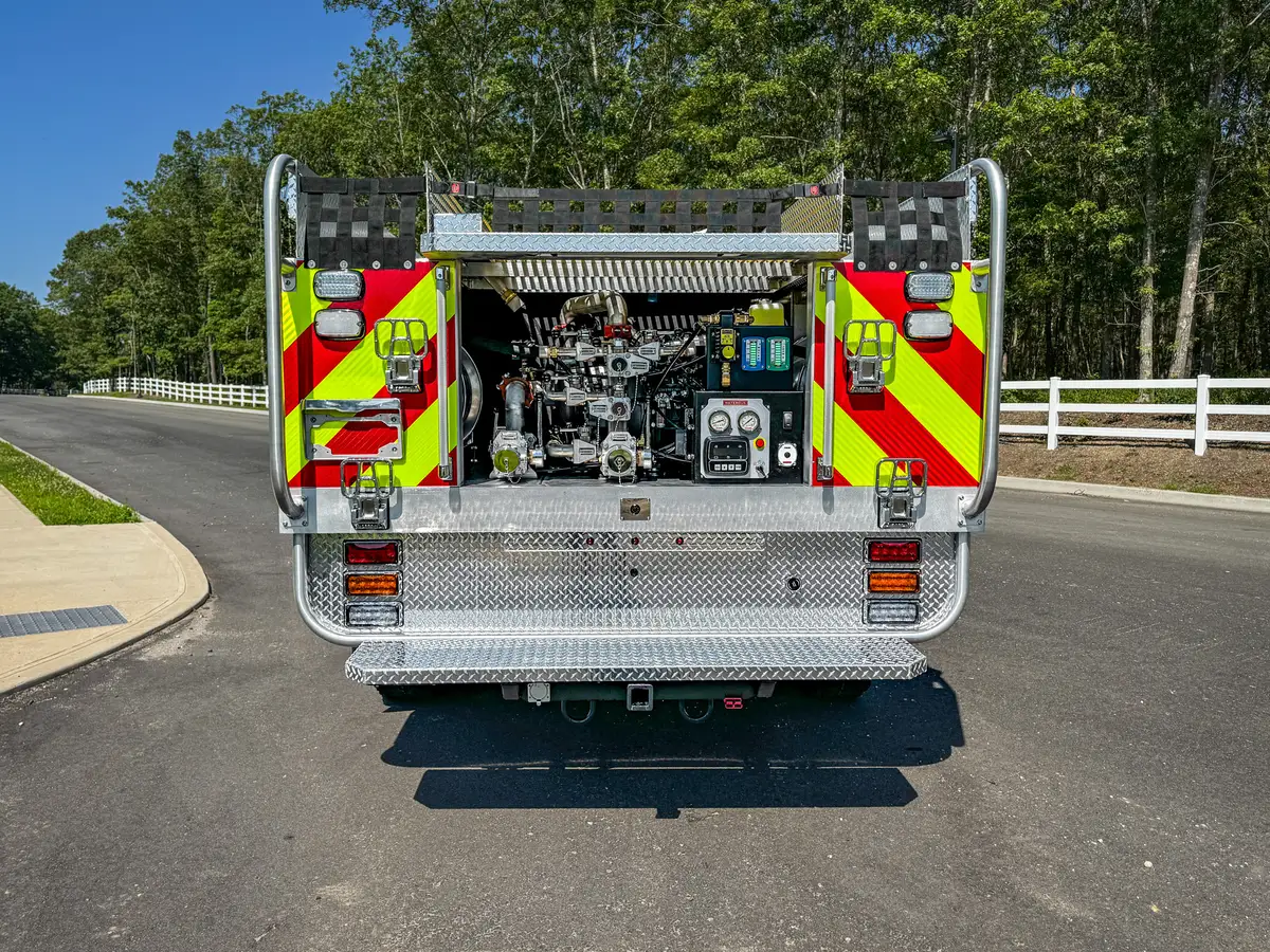 Rear-left exterior view with side roll-up and rear tailboard.